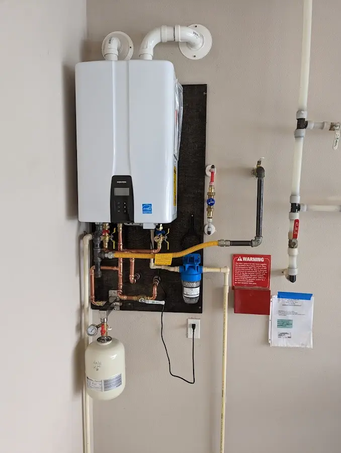 Professional plumber installing copper piping in a La Porte home